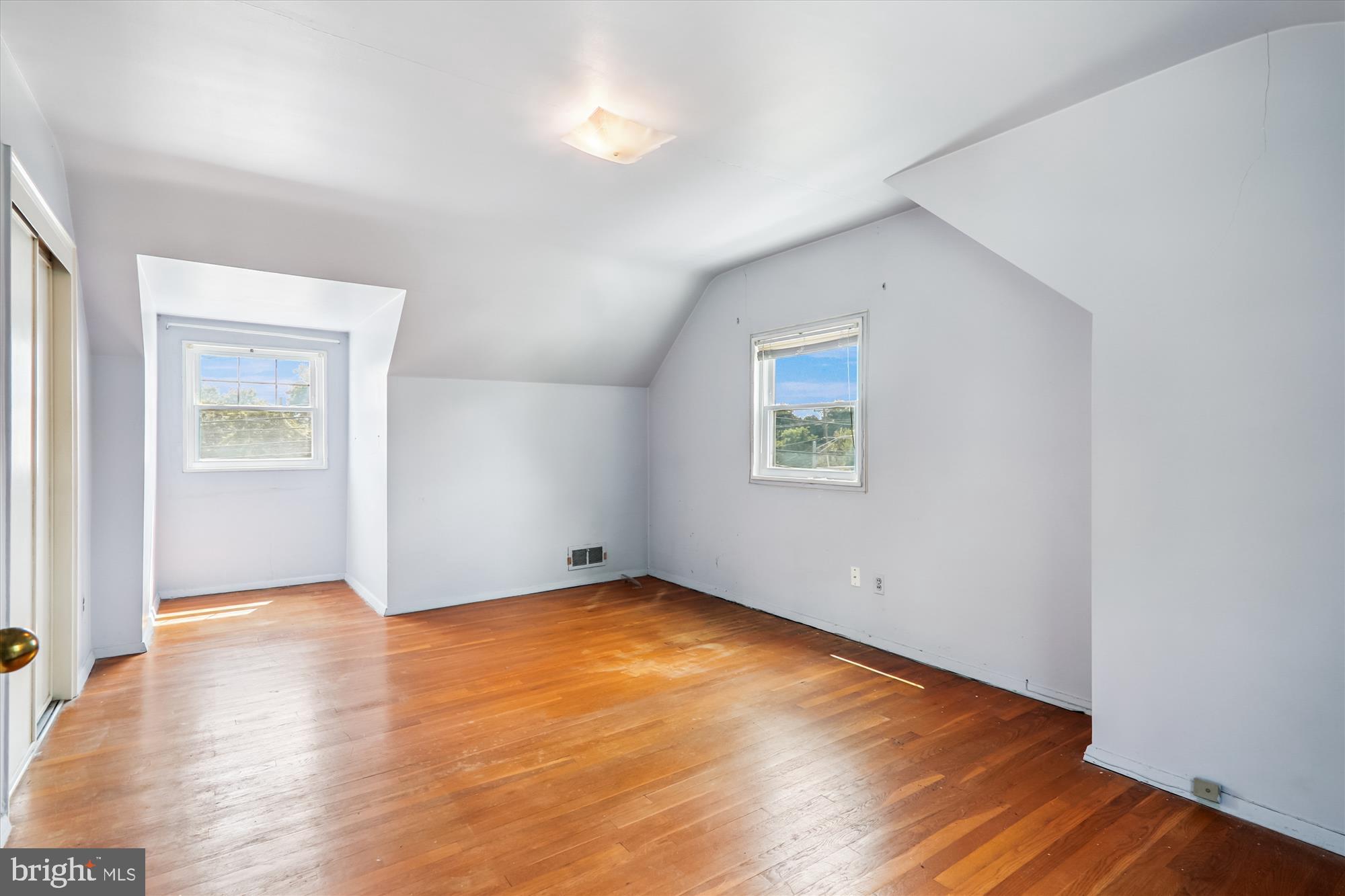 9507 Adelphi Road Silver Spring, MD 20903 - Photo 24 of 41 an empty room with wooden floor and windows