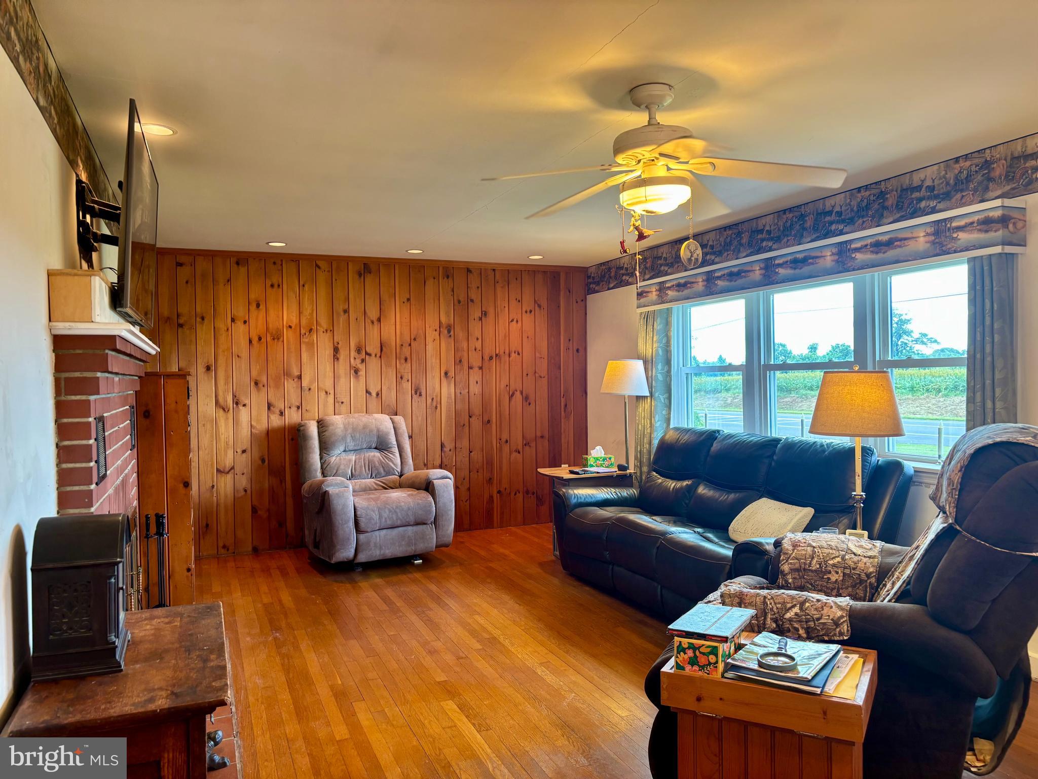 2101 Dudley Corners Road Crumpton, MD 21628 - Photo 12 of 40 a living room with furniture a chandelier and a window