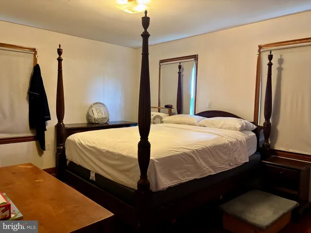 a bedroom with a bed and a walk in closet