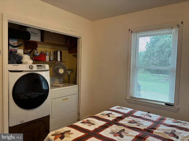 a bedroom with a bed and a window