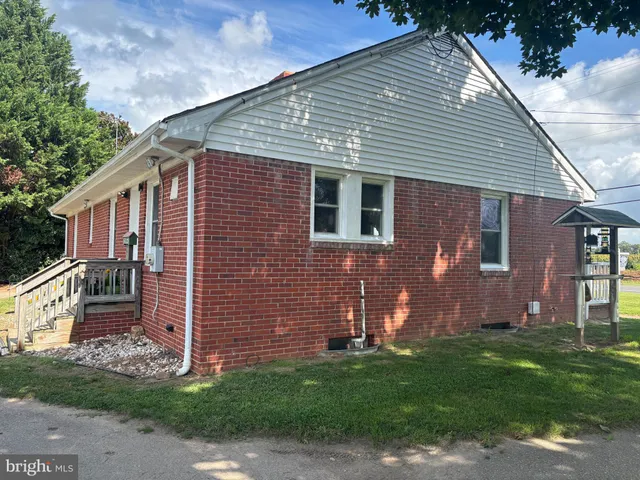 a front view of house with a garden