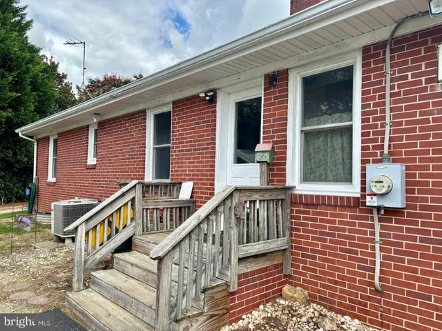 a view of a house with wooden deck