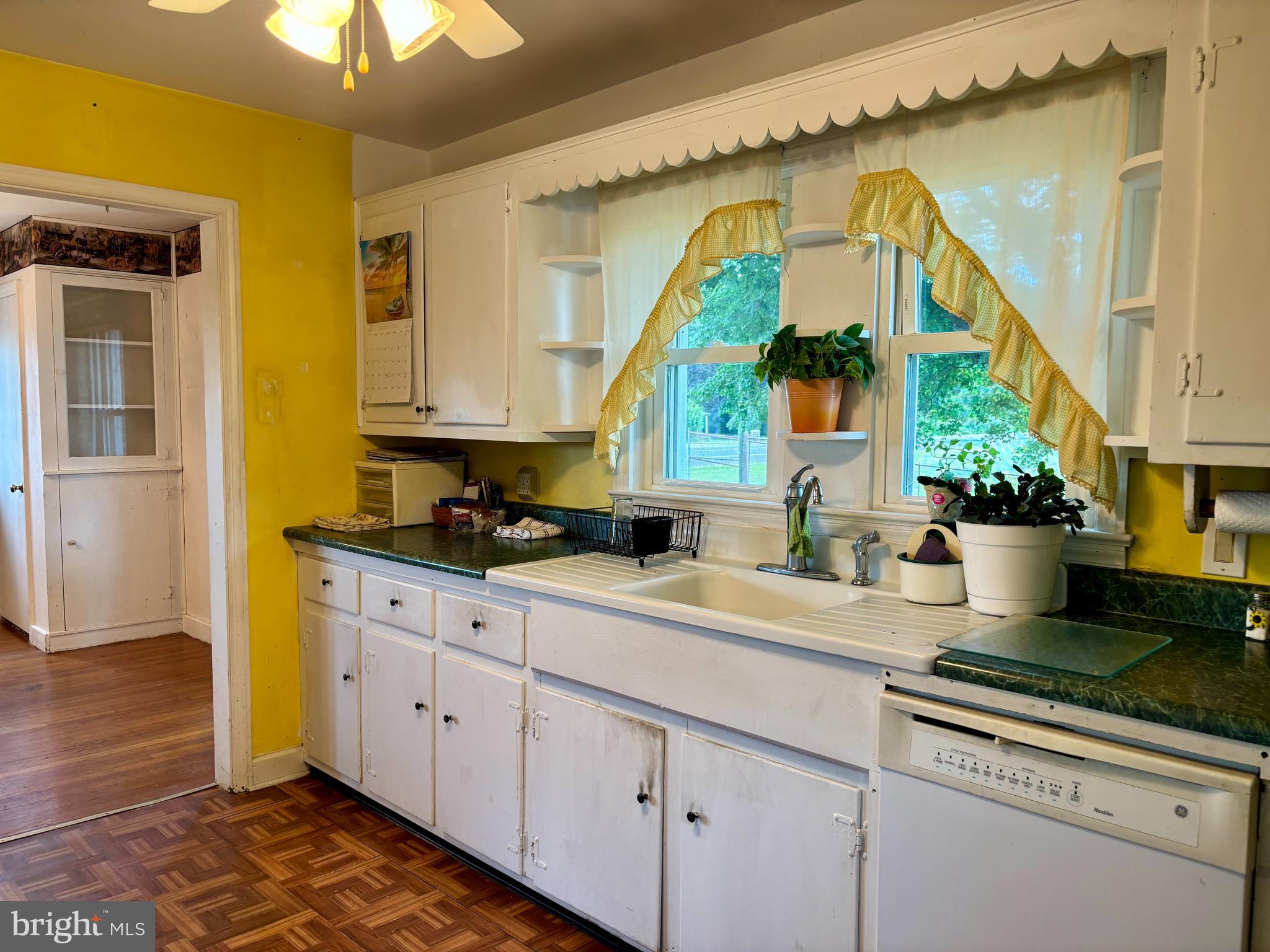 2101 Dudley Corners Road Crumpton, MD 21628 - Photo 4 of 40 a kitchen with stainless steel appliances granite countertop a sink a stove and a wooden floors