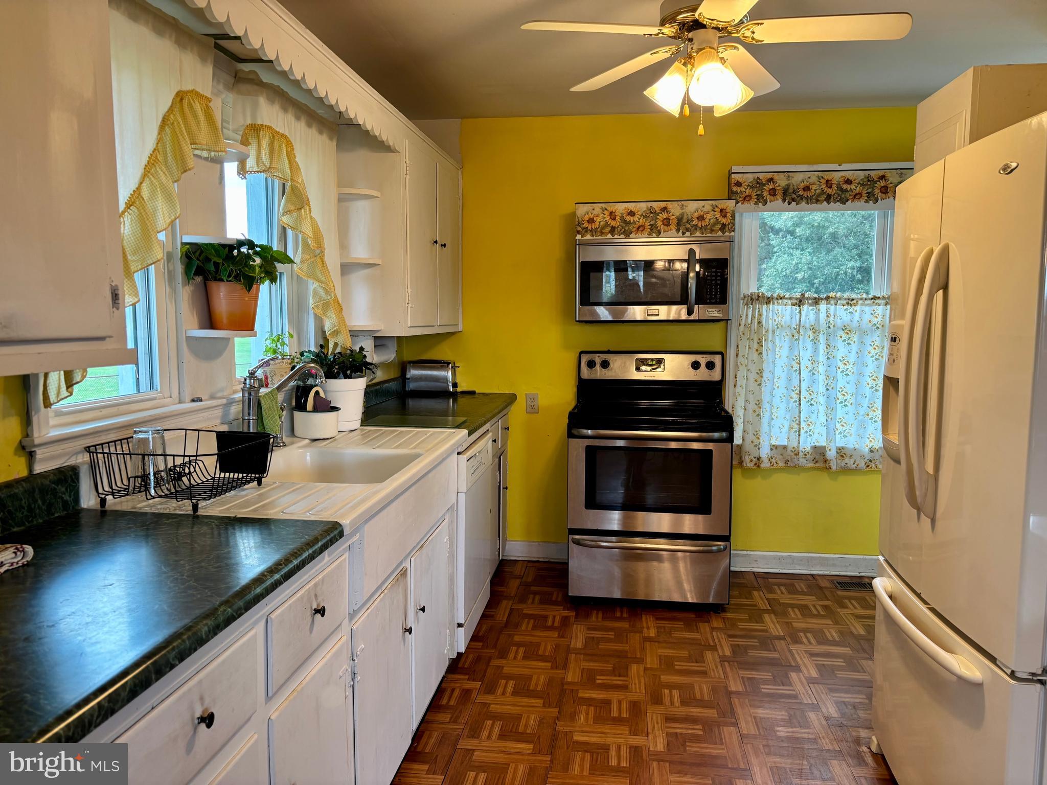 2101 Dudley Corners Road Crumpton, MD 21628 - Photo 5 of 40 a kitchen with a sink and a refrigerator