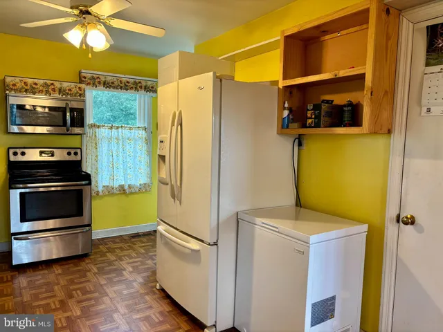 a kitchen with a refrigerator and a stove
