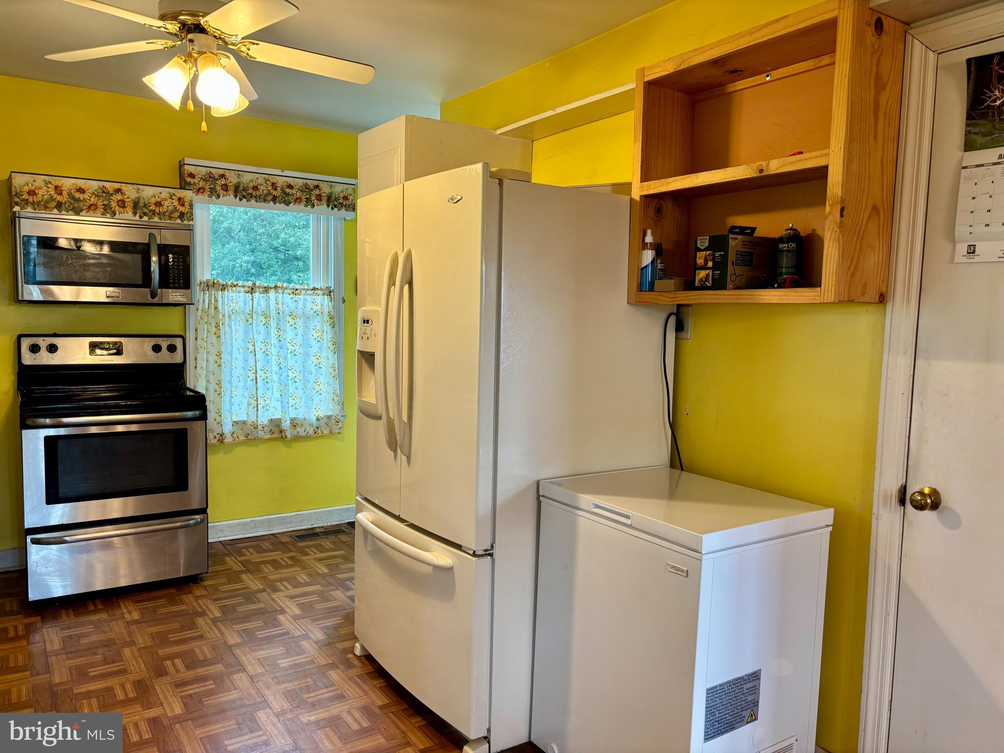 2101 Dudley Corners Road Crumpton, MD 21628 - Photo 7 of 40 a kitchen with a refrigerator and a stove