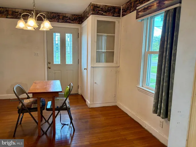 a view of a dining room with furniture and chandelier