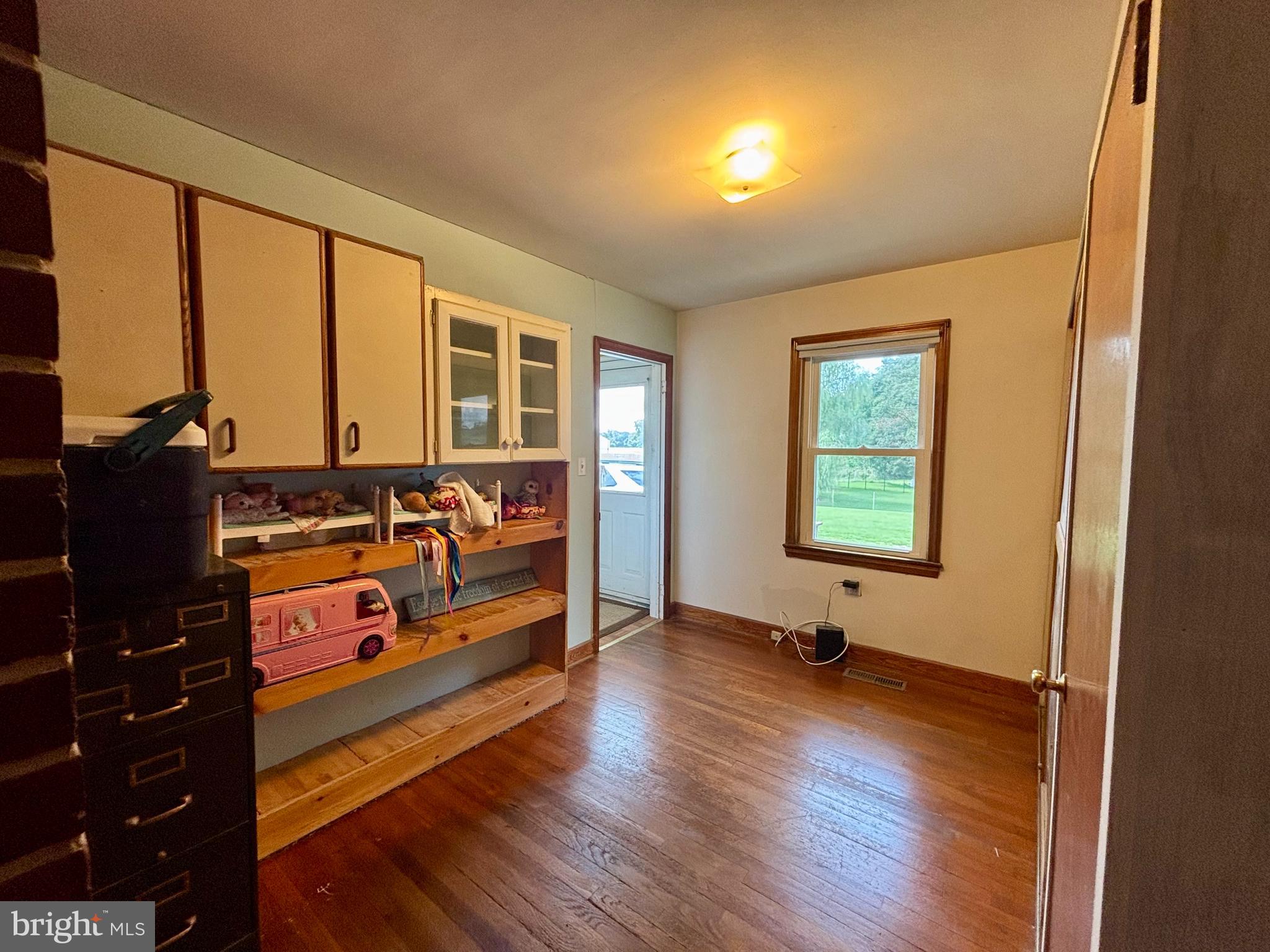 2101 Dudley Corners Road Crumpton, MD 21628 - Photo 10 of 40 an empty room with large windows and furniture