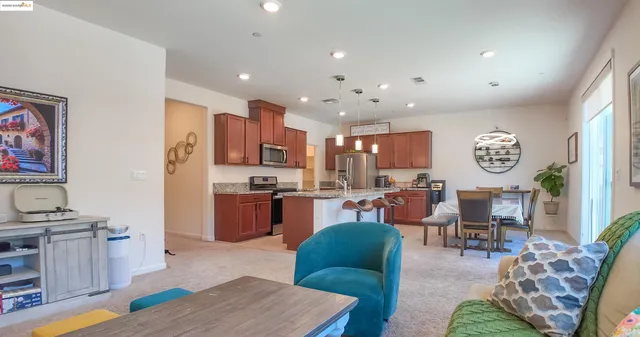 a living room with kitchen island furniture and a wooden floor
