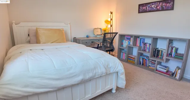 a bedroom with a bed and a book shelf