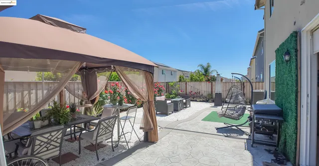 a view of a patio with table and chairs potted plants with wooden fence