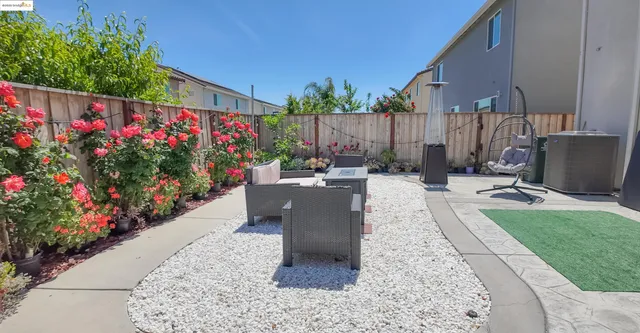 a view of a backyard with sitting area