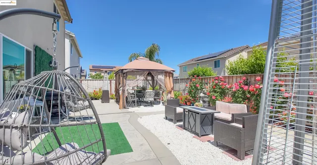 a view of a patio with a table and chairs