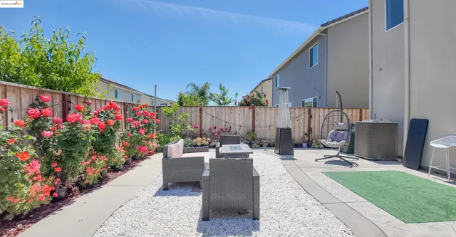 a view of a patio with a table and chairs and potted plants