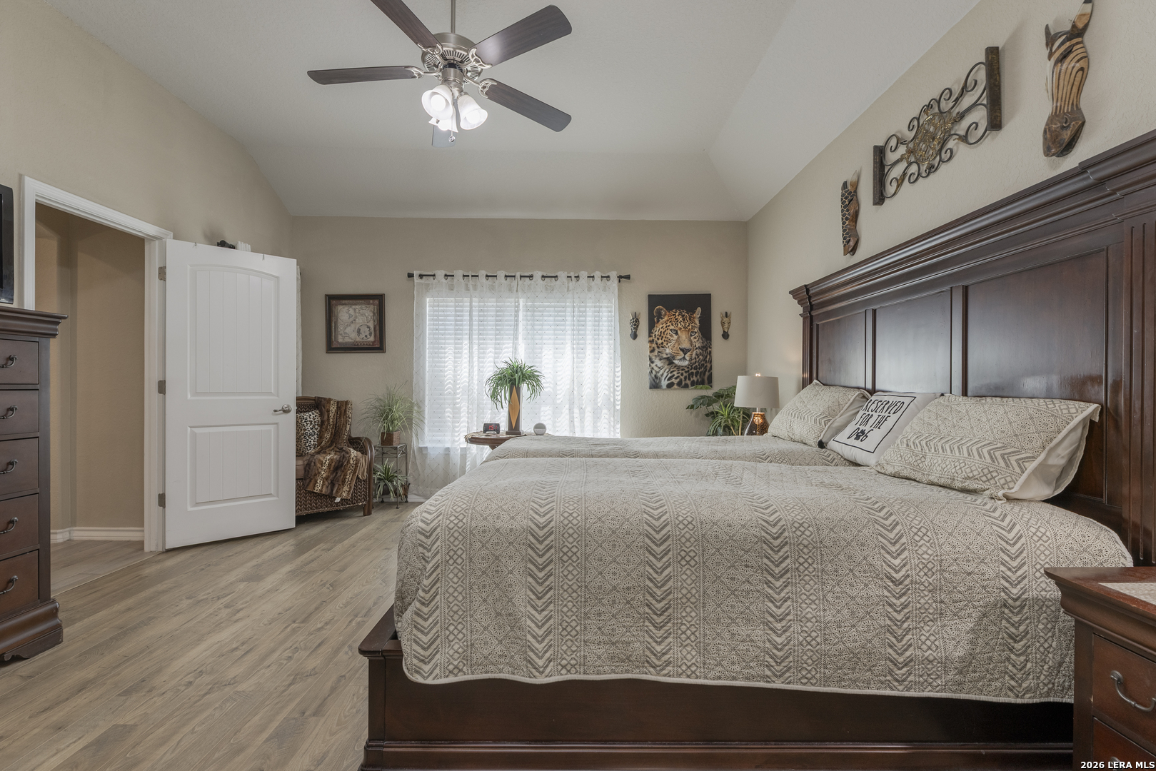133 Grand View Floresville, TX 78114 - Photo 11 of 43 a bedroom with a large bed and a chandelier