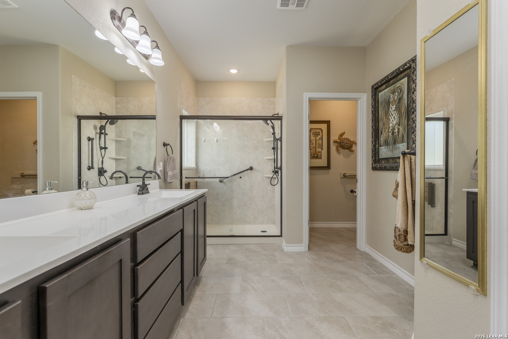 133 Grand View Floresville, TX 78114 - Photo 12 of 43 a bathroom with a granite countertop sink a shower and a mirror