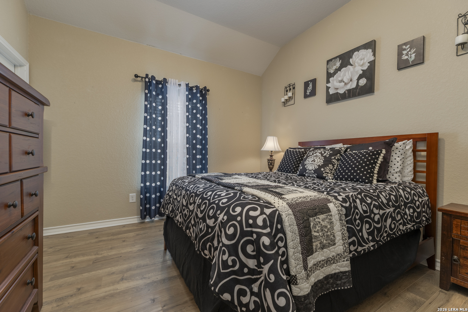 133 Grand View Floresville, TX 78114 - Photo 18 of 43 a bedroom with a bed and wooden floor