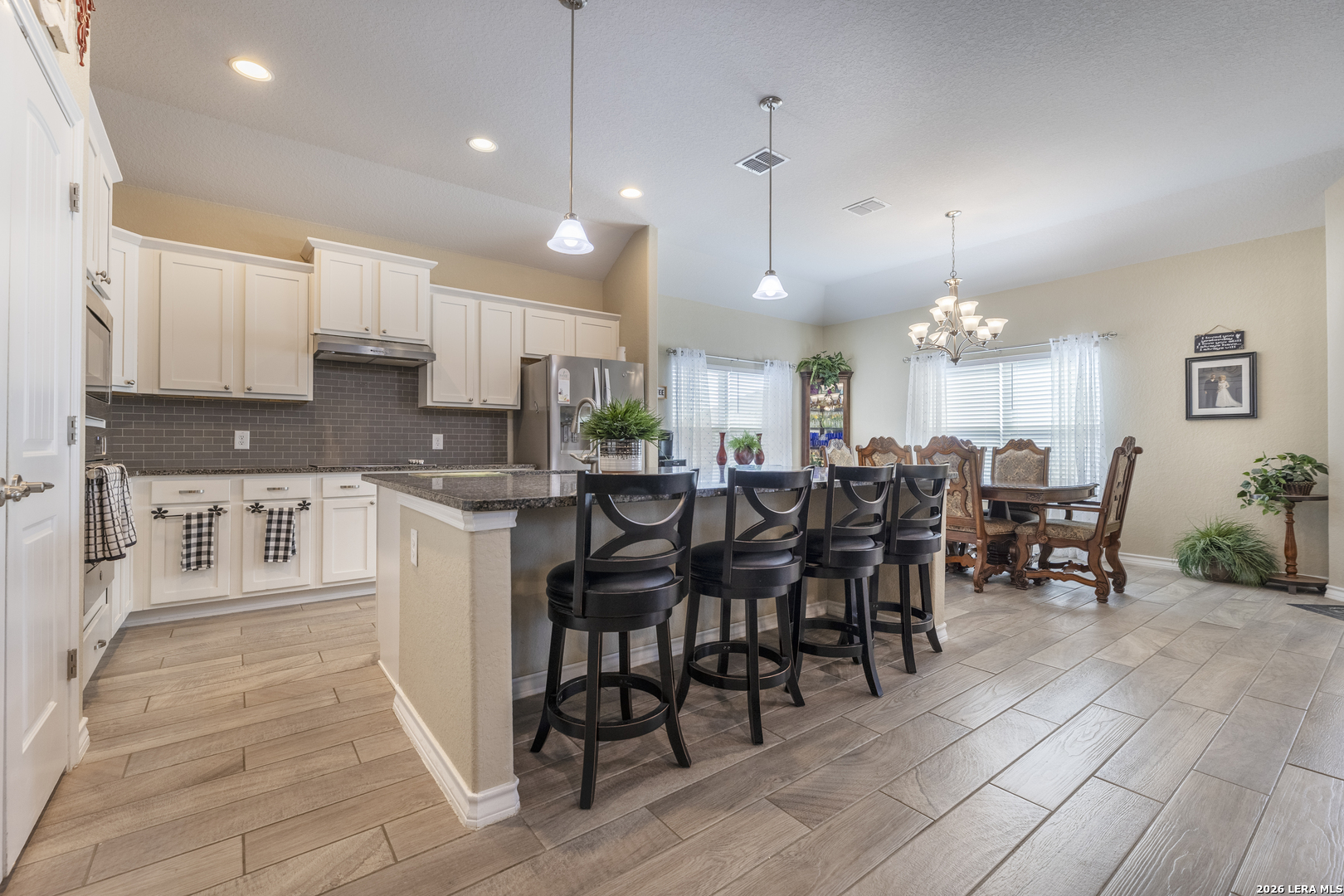 133 Grand View Floresville, TX 78114 - Photo 2 of 43 a large kitchen with lots of furniture a sink appliances and a dining table