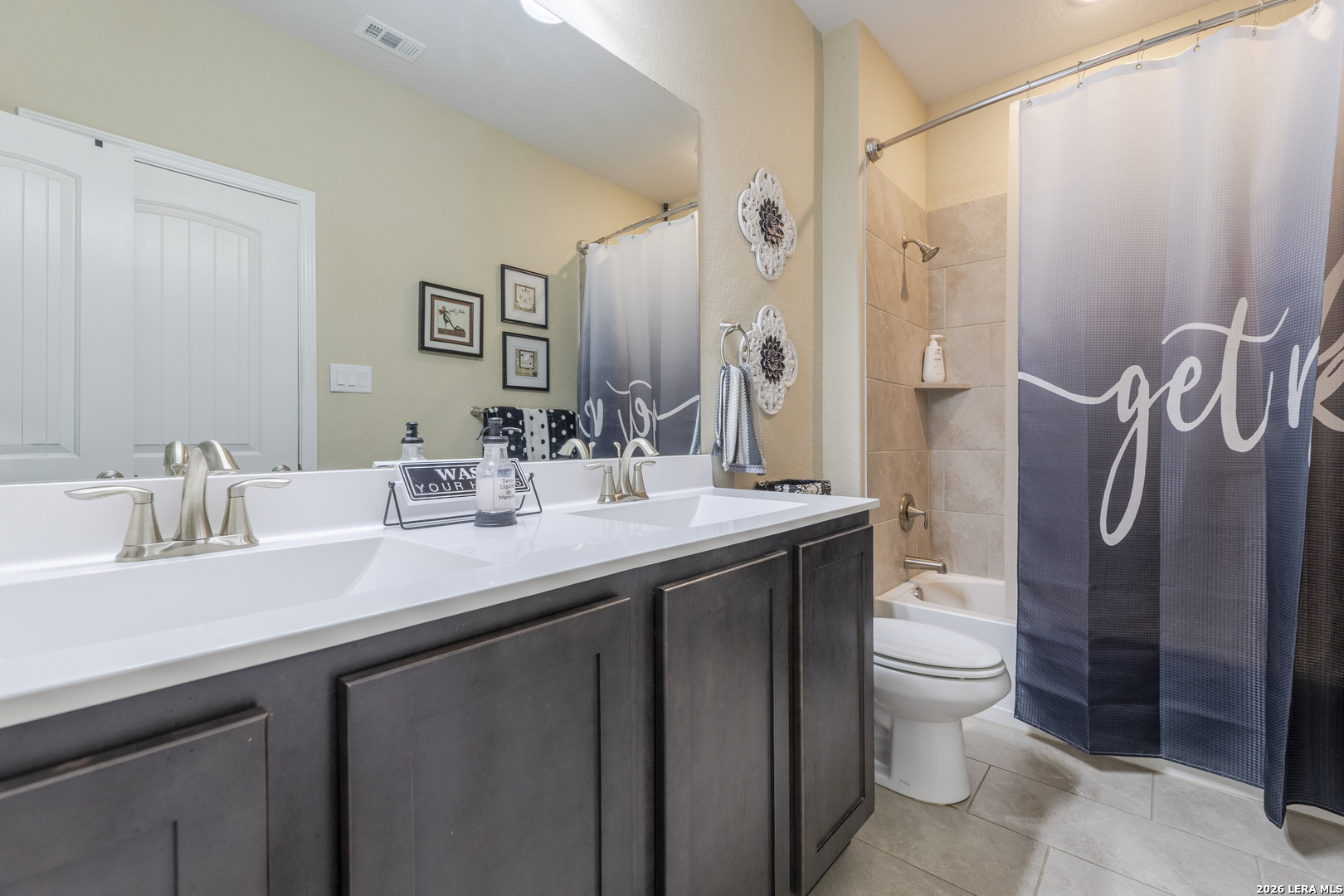 133 Grand View Floresville, TX 78114 - Photo 21 of 43 a bathroom with a double vanity sink toilet and shower