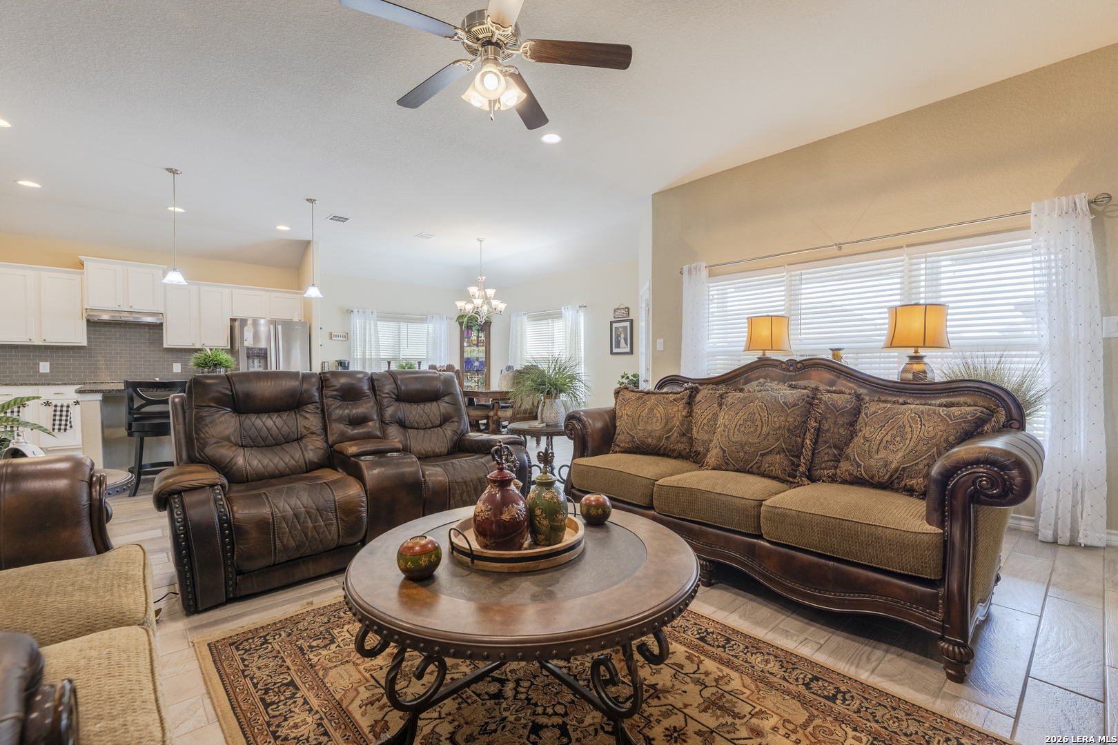 133 Grand View Floresville, TX 78114 - Photo 24 of 43 a living room with furniture a rug and a chandelier