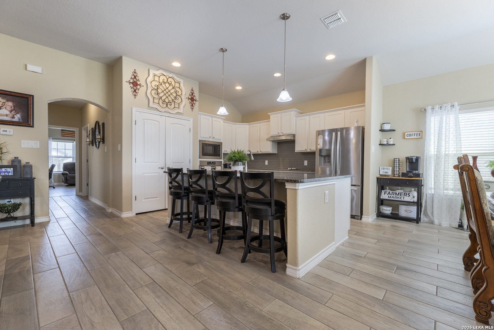 133 Grand View Floresville, TX 78114 - Photo 3 of 43 a kitchen with stainless steel appliances a refrigerator and a stove top oven