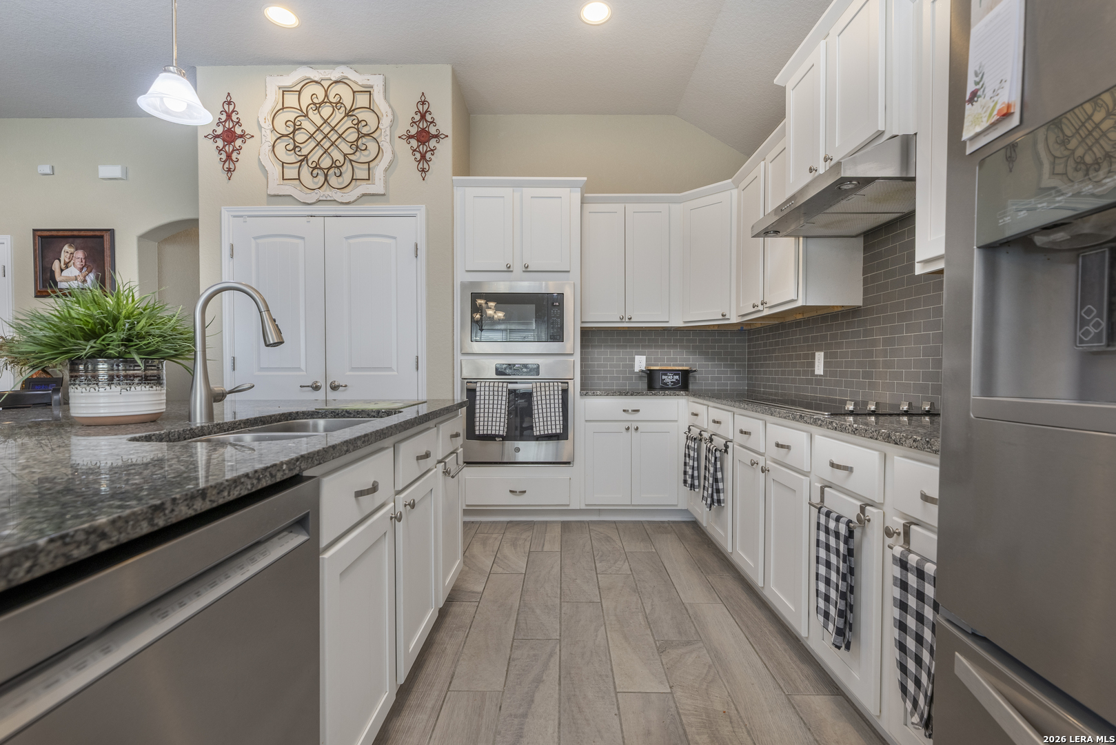 133 Grand View Floresville, TX 78114 - Photo 4 of 43 a kitchen with stainless steel appliances granite countertop a sink and cabinets