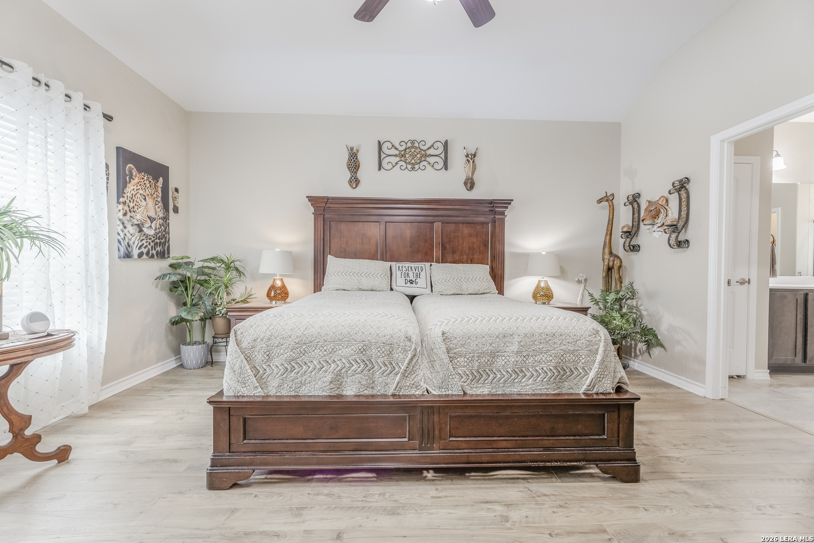 133 Grand View Floresville, TX 78114 - Photo 9 of 43 a bedroom with a bed and a potted plant