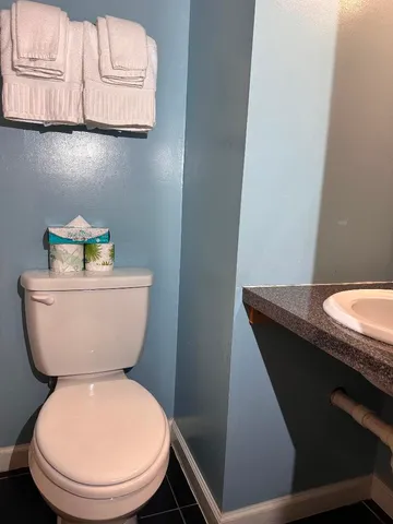 a bedroom with a bed and a mirror