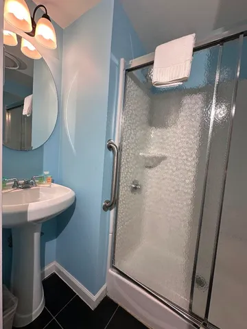 a white toilet sitting next to a bathroom sink