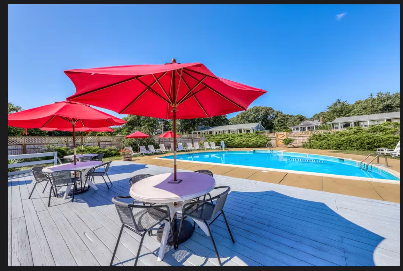21 Island Inn Road, Unit 39G Oak Bluffs, MA 02557 - Photo 2 of 31 a view of a patio with a table and chairs under an umbrella