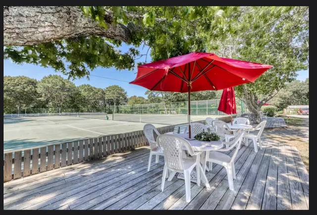 a view of balcony with wooden floor and outdoor seating
