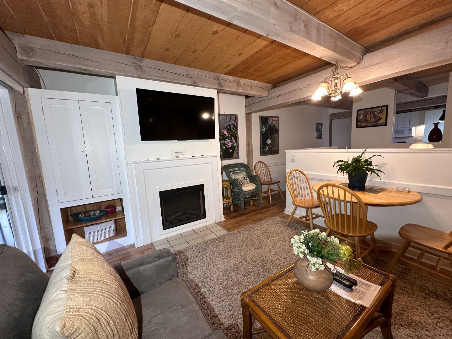 21 Island Inn Road, Unit 39G Oak Bluffs, MA 02557 - Photo 8 of 31 a living room with furniture a flat screen tv and a fireplace
