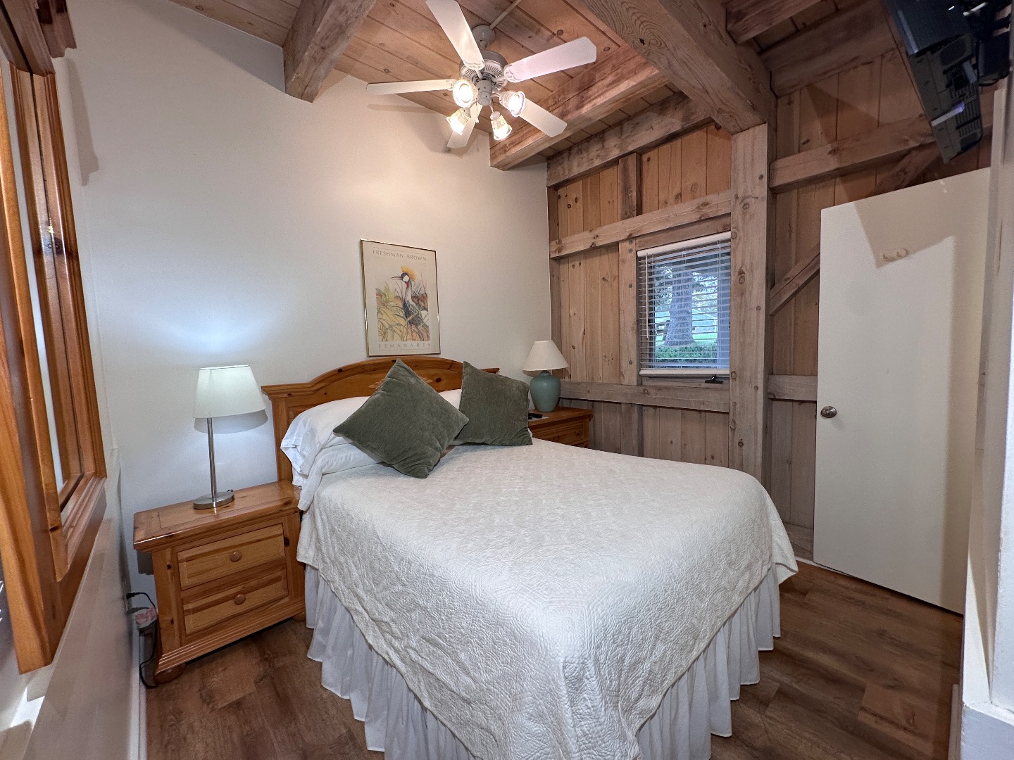 21 Island Inn Road, Unit 39G Oak Bluffs, MA 02557 - Photo 9 of 31 a bedroom with a bed and a chandelier