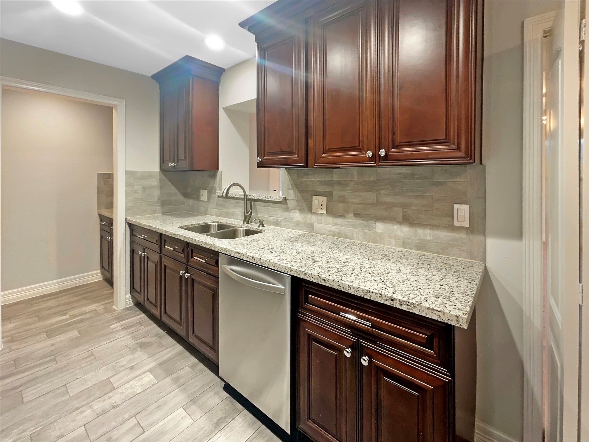 12107 Pompton Drive Houston, TX 77089 - Photo 13 of 23 a kitchen with stainless steel appliances granite countertop wooden cabinets and sink