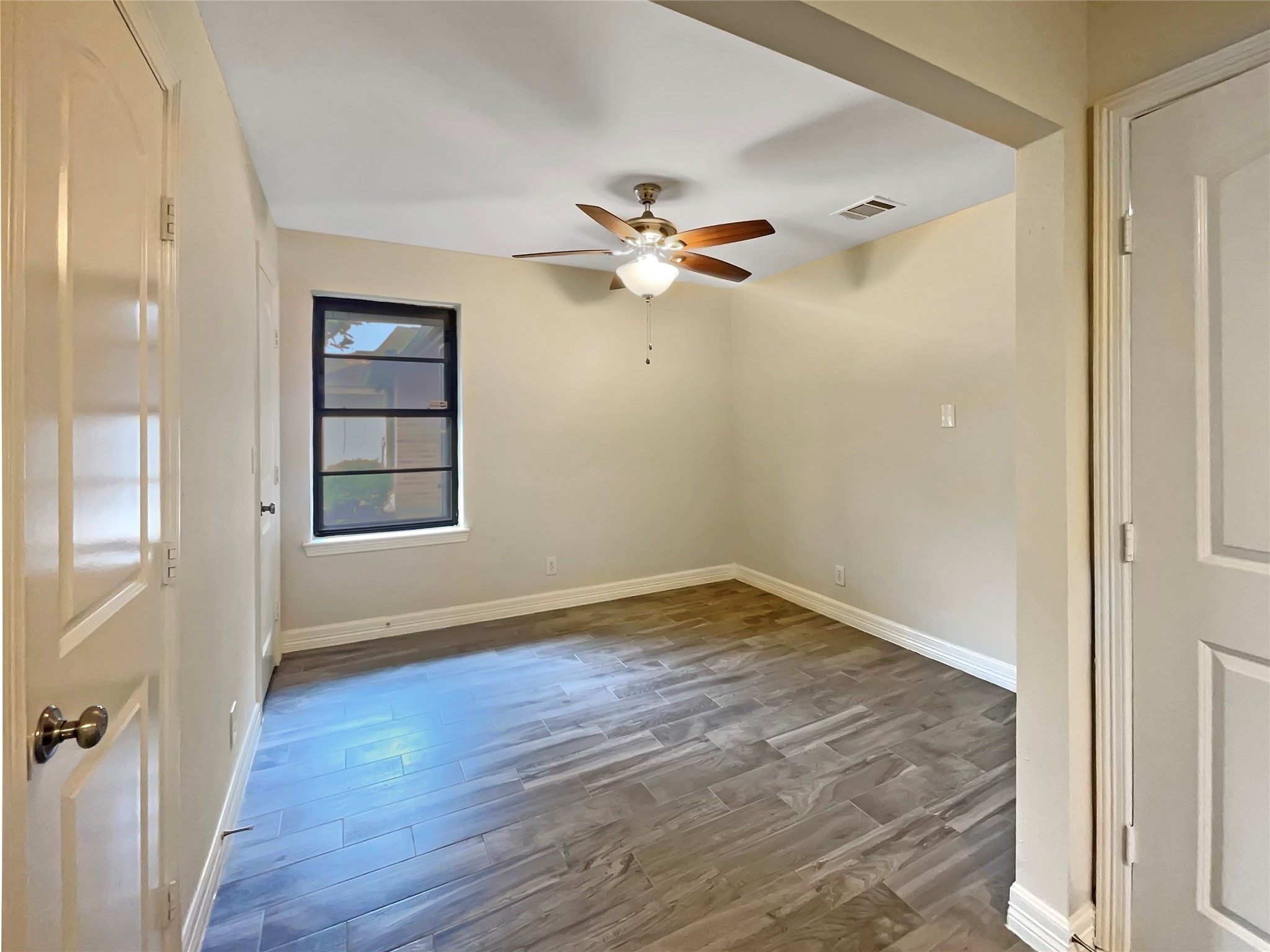 12107 Pompton Drive Houston, TX 77089 - Photo 19 of 23 a view of empty room with wooden floor and fan