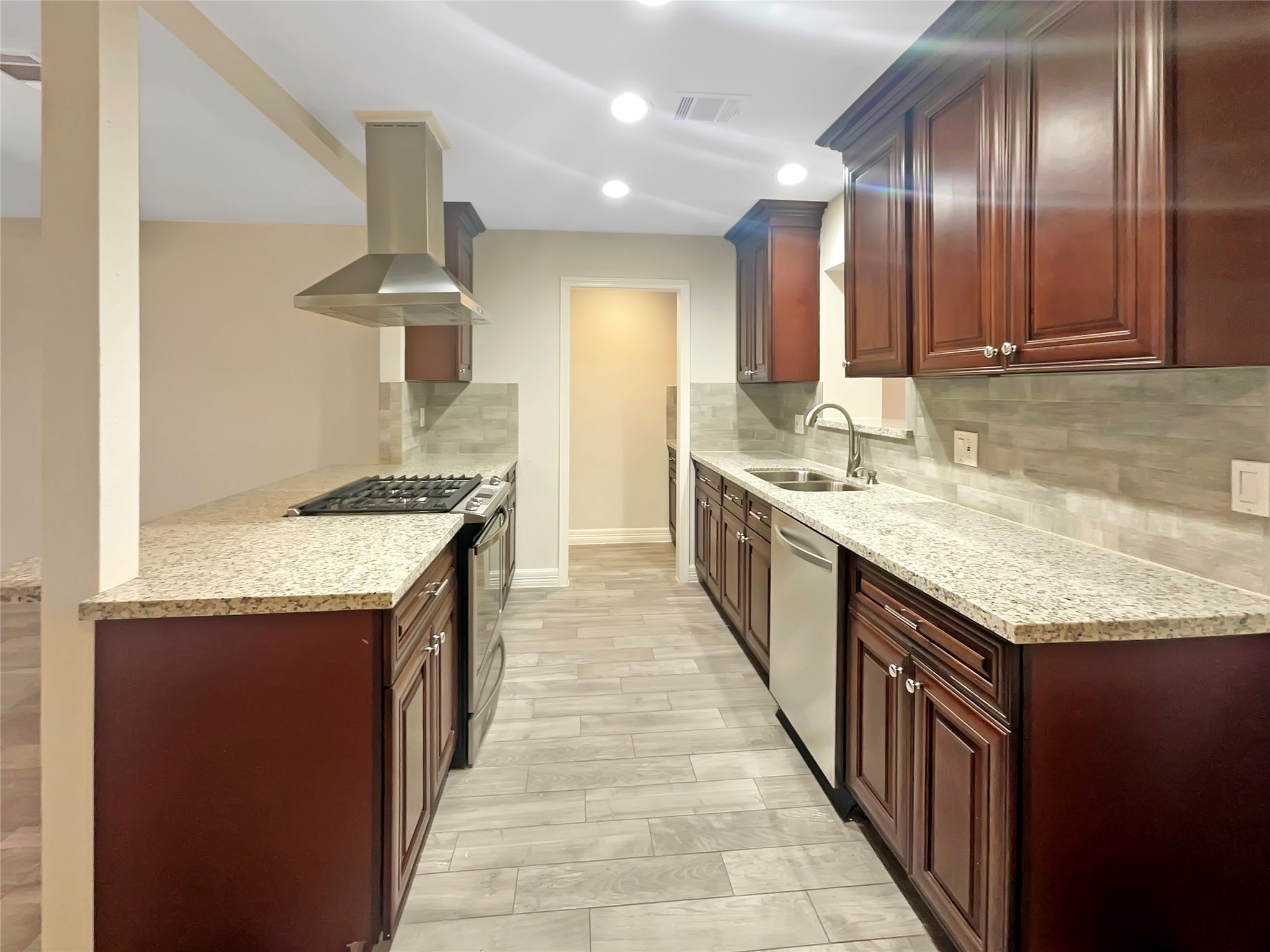 12107 Pompton Drive Houston, TX 77089 - Photo 2 of 23 a kitchen with granite countertop stainless steel appliances a sink stove and cabinets
