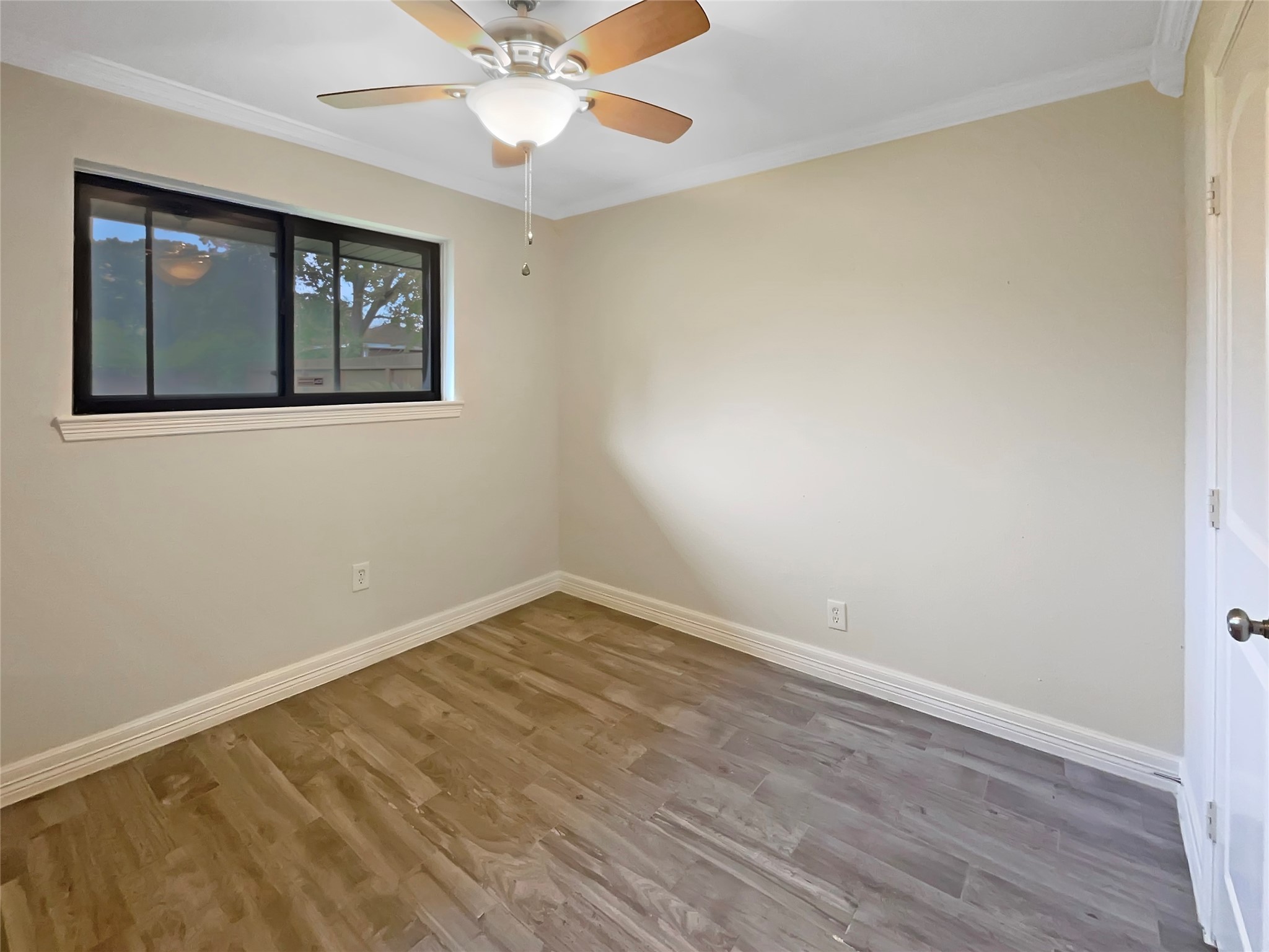 12107 Pompton Drive Houston, TX 77089 - Photo 4 of 23 a view of an empty room with wooden floor and a window
