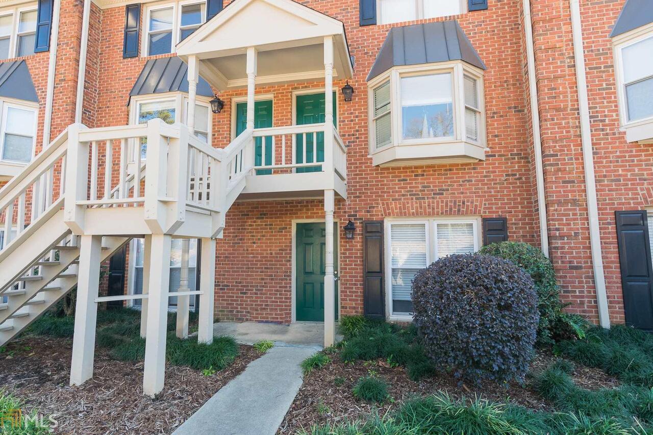 210 East Cloverhurst Avenue, Unit 7 Athens, GA 30605 - Photo 1 of 1 a view of a brick building next to a yard