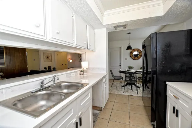 a kitchen with a sink cabinets and outdoor space