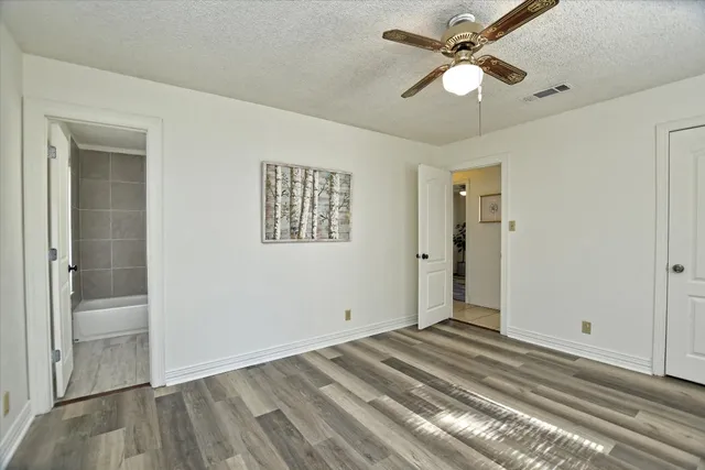 a view of a bedroom with wooden floor