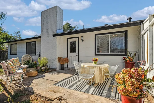 a front view of house with yard outdoor seating and barbeque oven