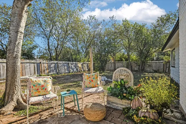 a view of a chairs and table in the patio