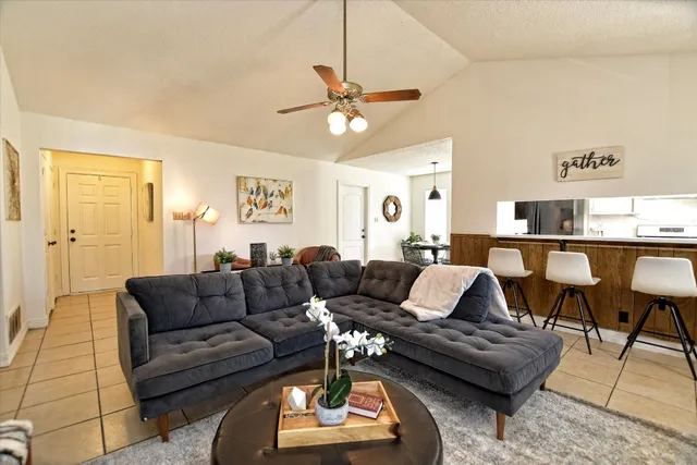 a living room with furniture and a chandelier