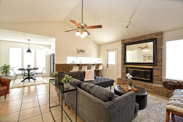 a living room with fireplace furniture and a flat screen tv