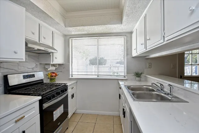 a kitchen that has a sink and a stove