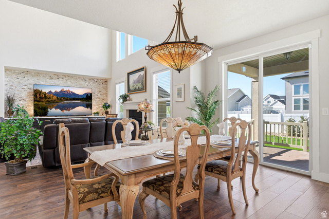 1434 West Stable Street Lindon, UT 84042 - Photo 14 of 76 Dining room featuring wood finished floors, a fireplace, and a high ceiling