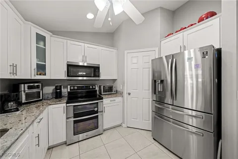 a kitchen with stainless steel appliances and refrigerator