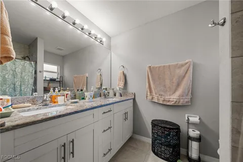 a bathroom with a double vanity sink and a mirror