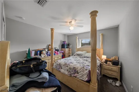 a bedroom with furniture and a chandelier