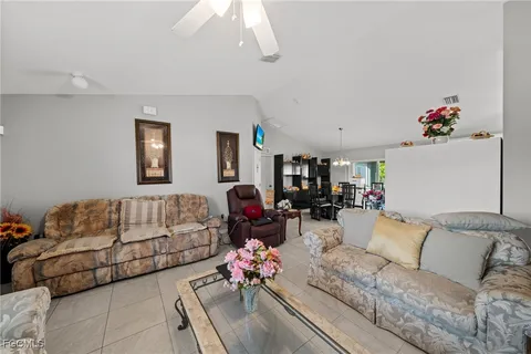 a living room with furniture and flowers